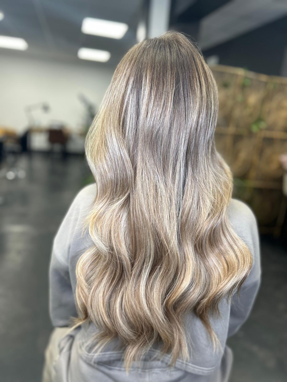 Nano Ring hair extensions by Unit G, finished in long, softly waved blonde hair